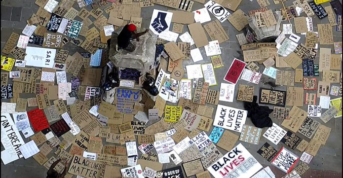 an aerial view of placards surrounding the plinth where the colston statue was