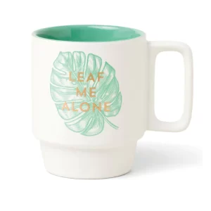a mug with a picture of a leaf and 'leaf me alone' printed on it