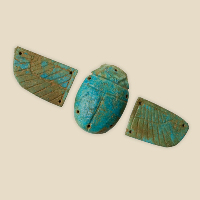 Ancient Egyptian amulet in three parts showing a scarab beetle and two wings made of faience.