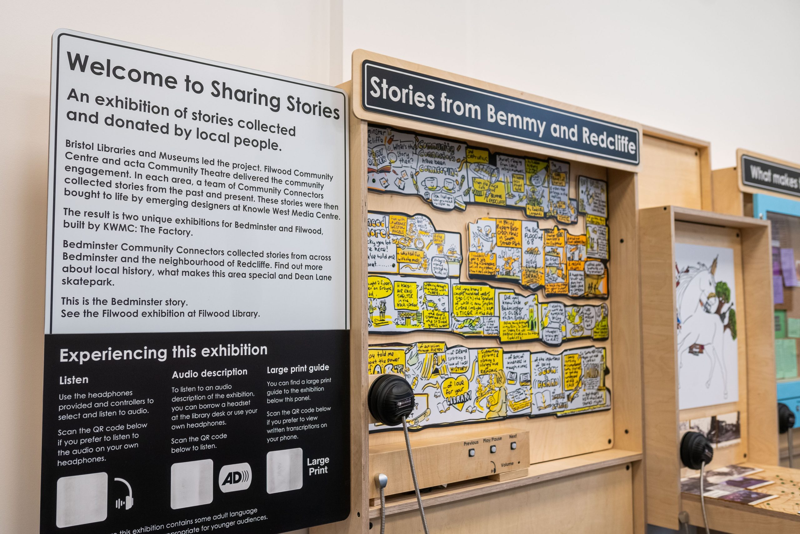 A wood frame exhibition. The top reads 'Stories from Benny and Redcliffe', the side reads 'Welcome to Sharing Stories'. There are opportunities for listening and illustrations.