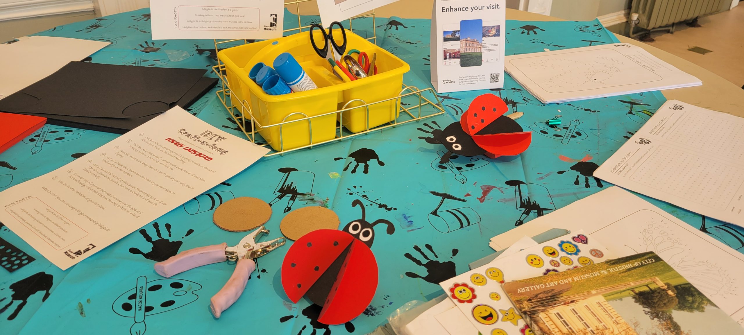 a table of crafts and tools including card ladybirds