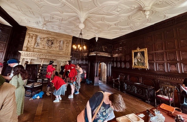 a group of people in a oak panelled historic house at an open event