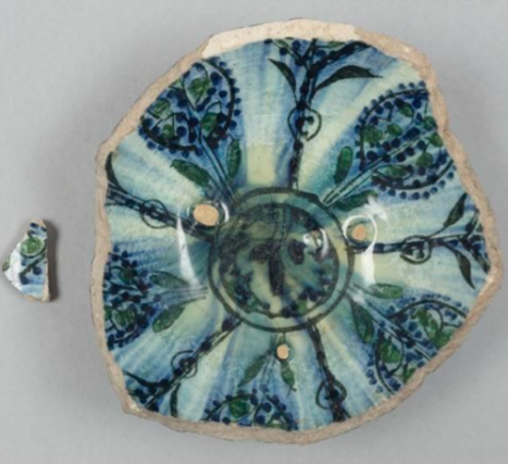 A round blue decorative shard of pottery