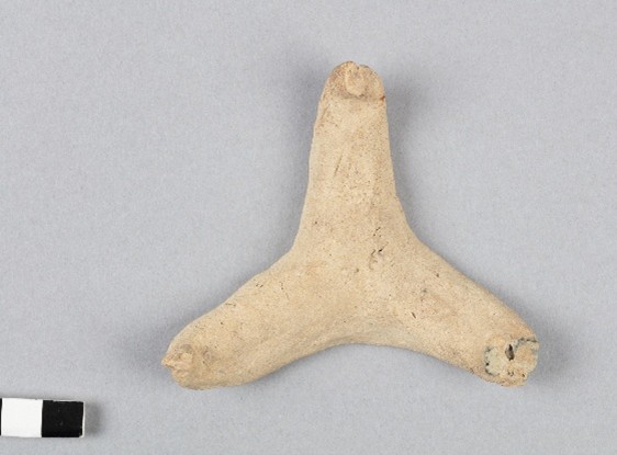 A tiny three pointed clay stand