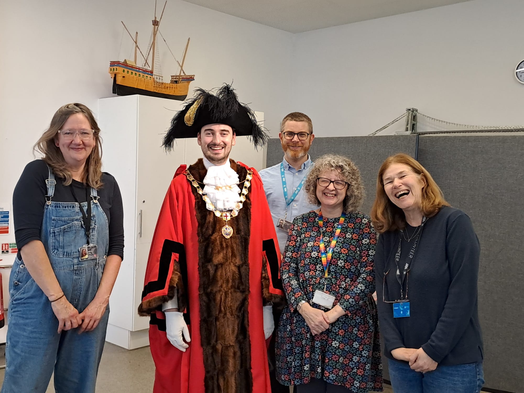 a Lord Mayor poses with four staff members smiling at a museums event