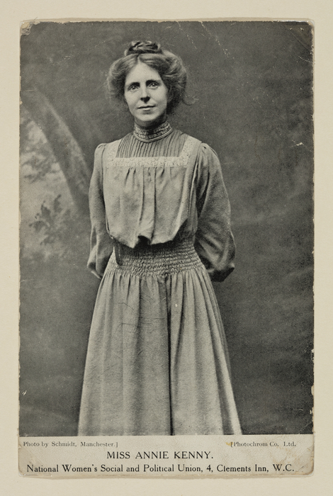 A woman in Edwardian dress with fair hair in a loose bun