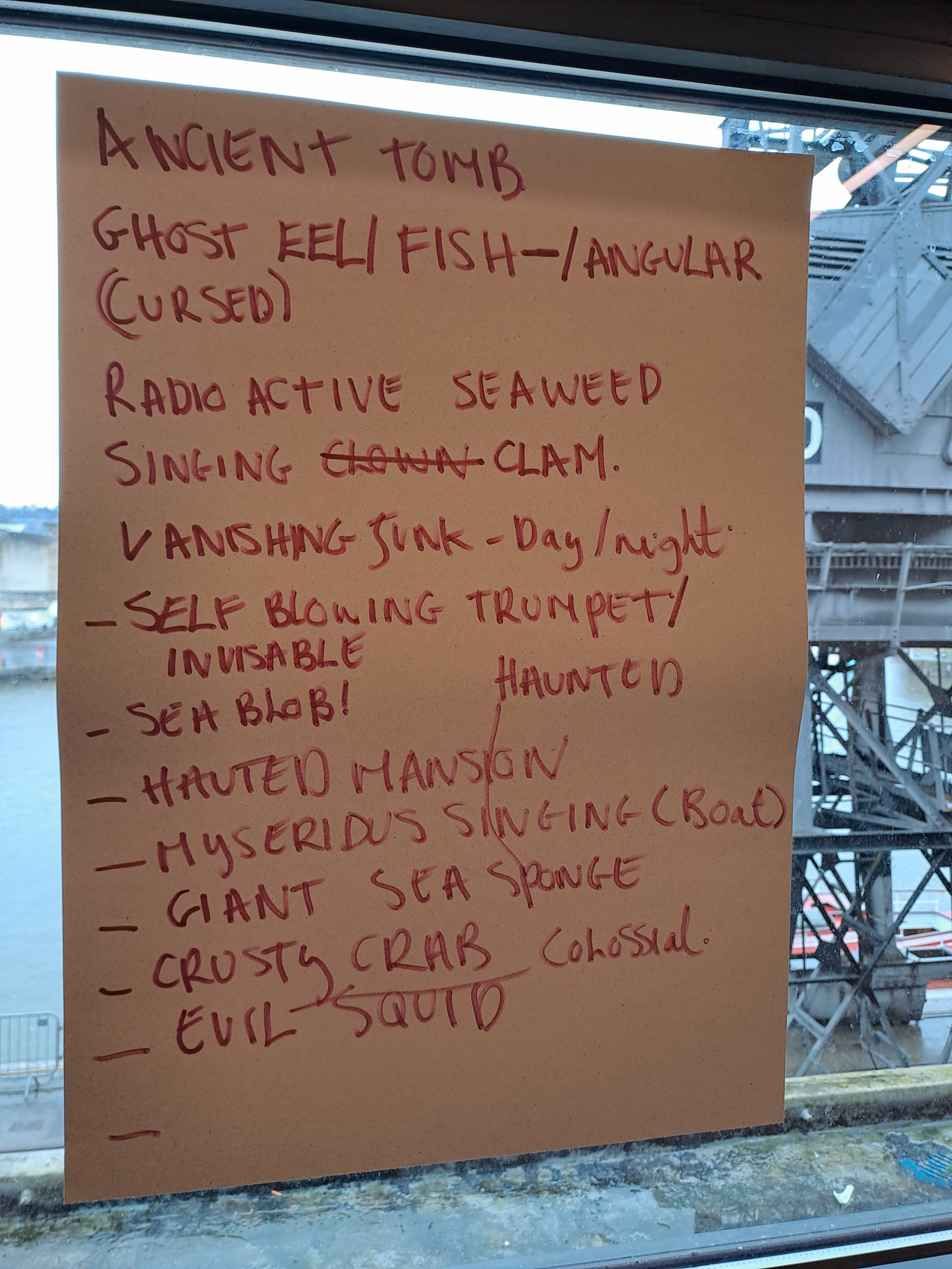 a sheet of large paper with writing on it pinned to a window